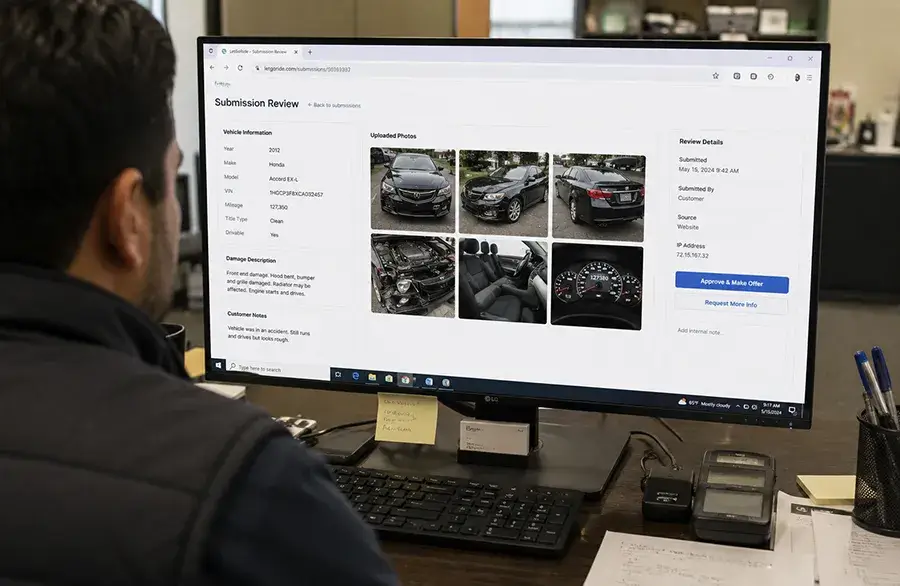 Team member reviewing an online vehicle submission